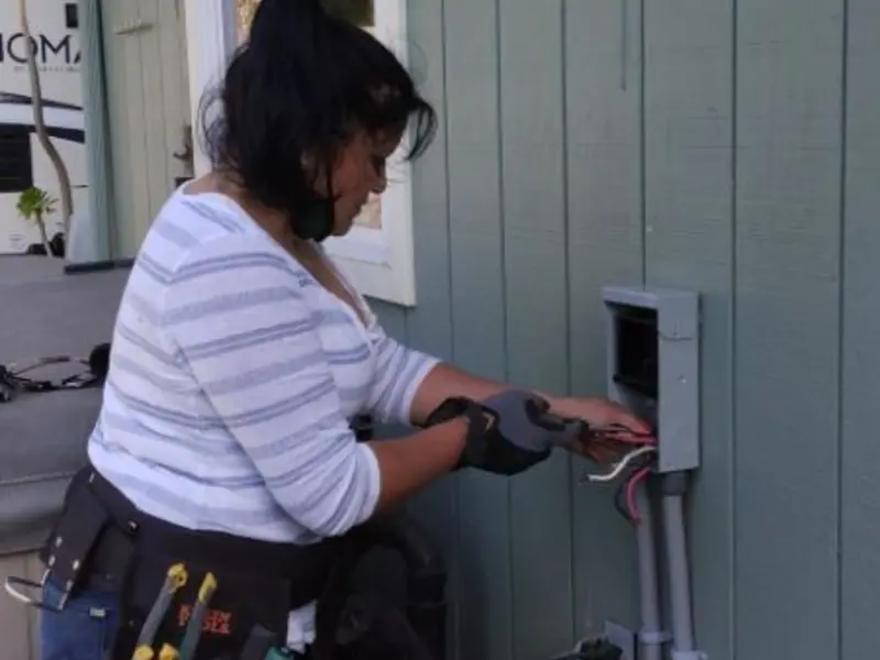 Licensed electrician wiring an exterior subpanel in Cocoa